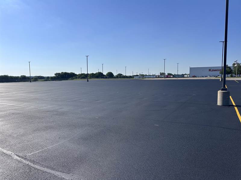 Worn, faded striping on a parking lot before restoration