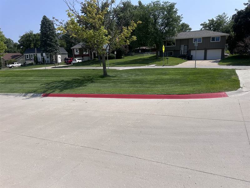 Freshly painted yellow fire lane curb along a building entrance