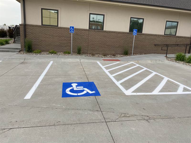 Freshly painted ADA-compliant accessible parking stalls with signage