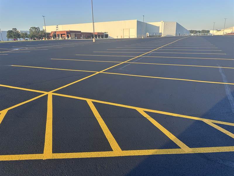 Freshly painted stalls across a large industrial property parking lot