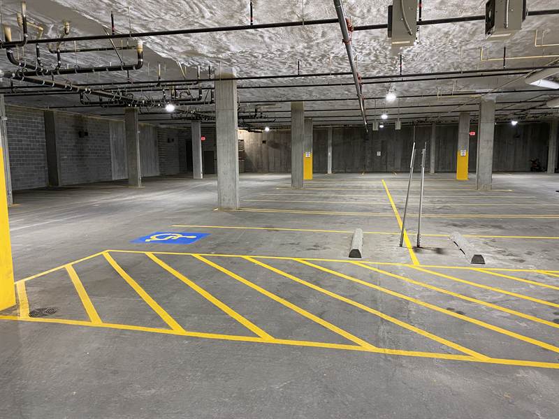 Freshly painted traffic lanes and markings inside a multi-level parking garage