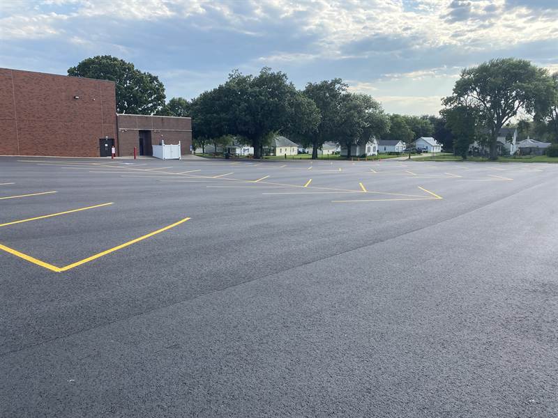 Freshly striped school parking lot with clean yellow lines on new asphalt