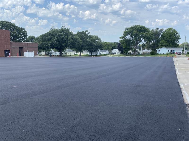 Newly paved school parking lot with no striping yet