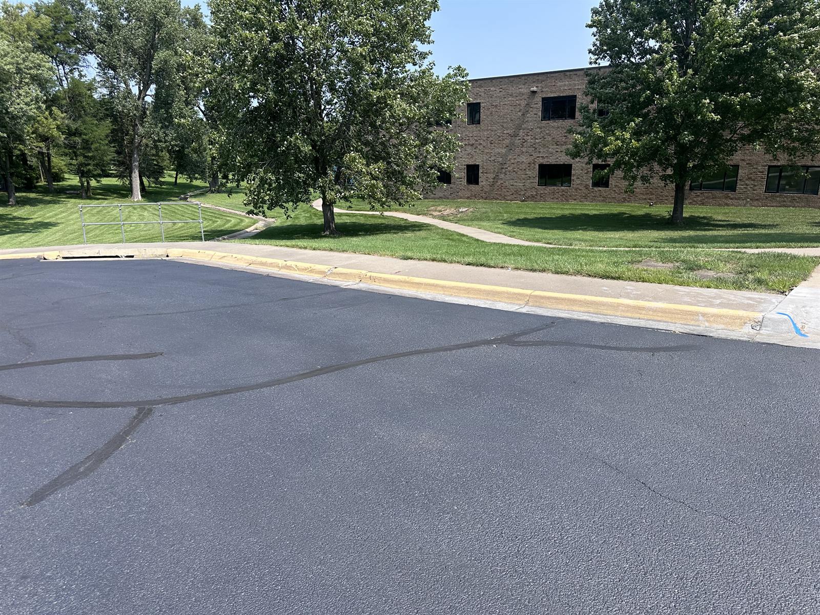 Faded, chipped yellow curb paint before repainting