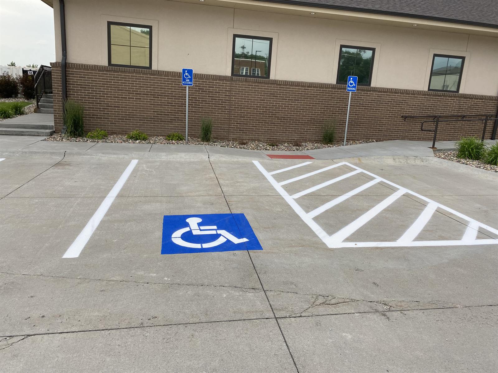 Freshly painted ADA-compliant accessible parking stalls with access aisle and ISA symbol