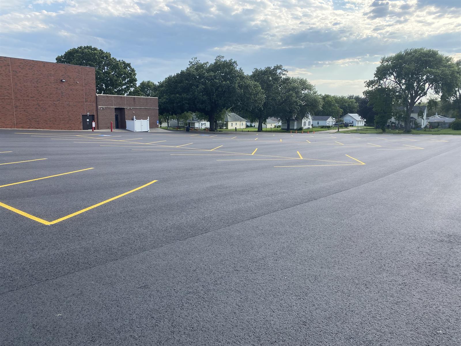Freshly striped school parking lot with clean yellow lines on new asphalt